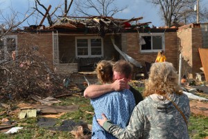 Ray Baughman embraces family shortly after his home was destroyed by a tornado that left a path of devastation through the north end of Pekin, Il., Sunday, Nov. 17, 2013. Intense thunderstorms and tornadoes swept across the Midwest on Sunday, causing extensive damage in several central Illinois communities while sending people to their basements for shelter. (AP Photo/Journal Star, Fred Zwicky) MANDATORY CREDIT